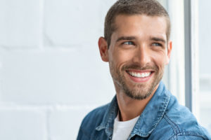 Happy smiling man looking away | Periodontal disease 