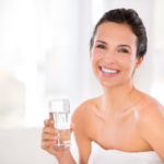 Portrait of a beautiful woman holding a glass of water