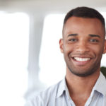 Portrait of a young office worker standing in an | Periodontal Disease