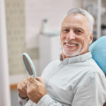 Elderly man in dentist's chair without fear waiting for treatment of their teeth