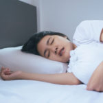Women sleeping on the bed and grinding teeth